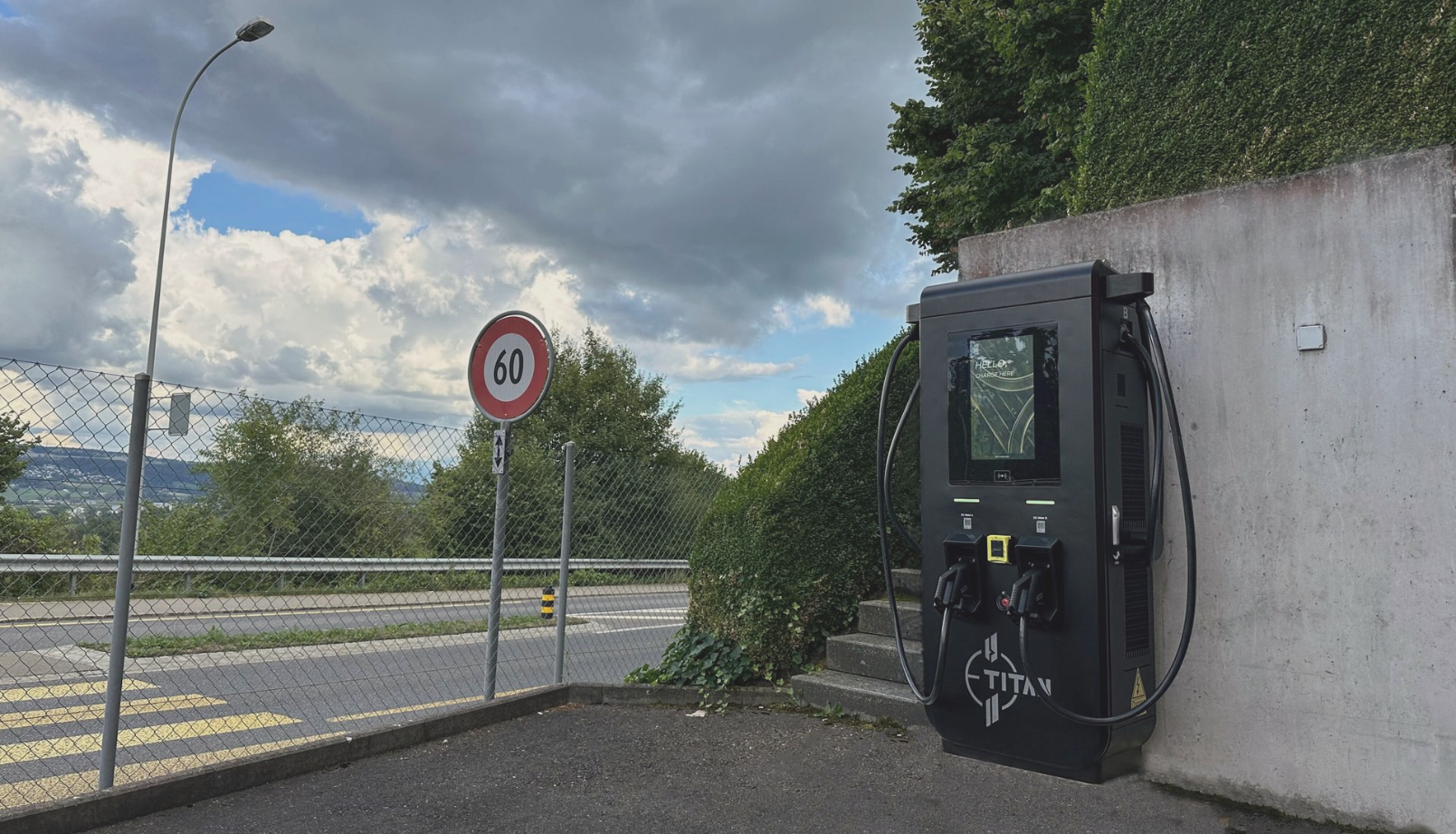DC Schnelladestation der E-Titan AG an einer Strasse, im Hintergrund Ausblick auf das Land